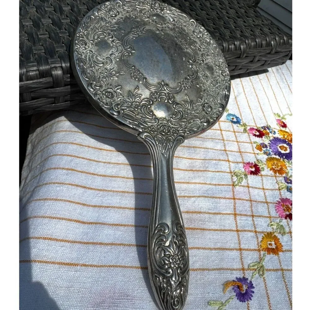 Vintage silver tone hand mirror embossed design on back so pretty